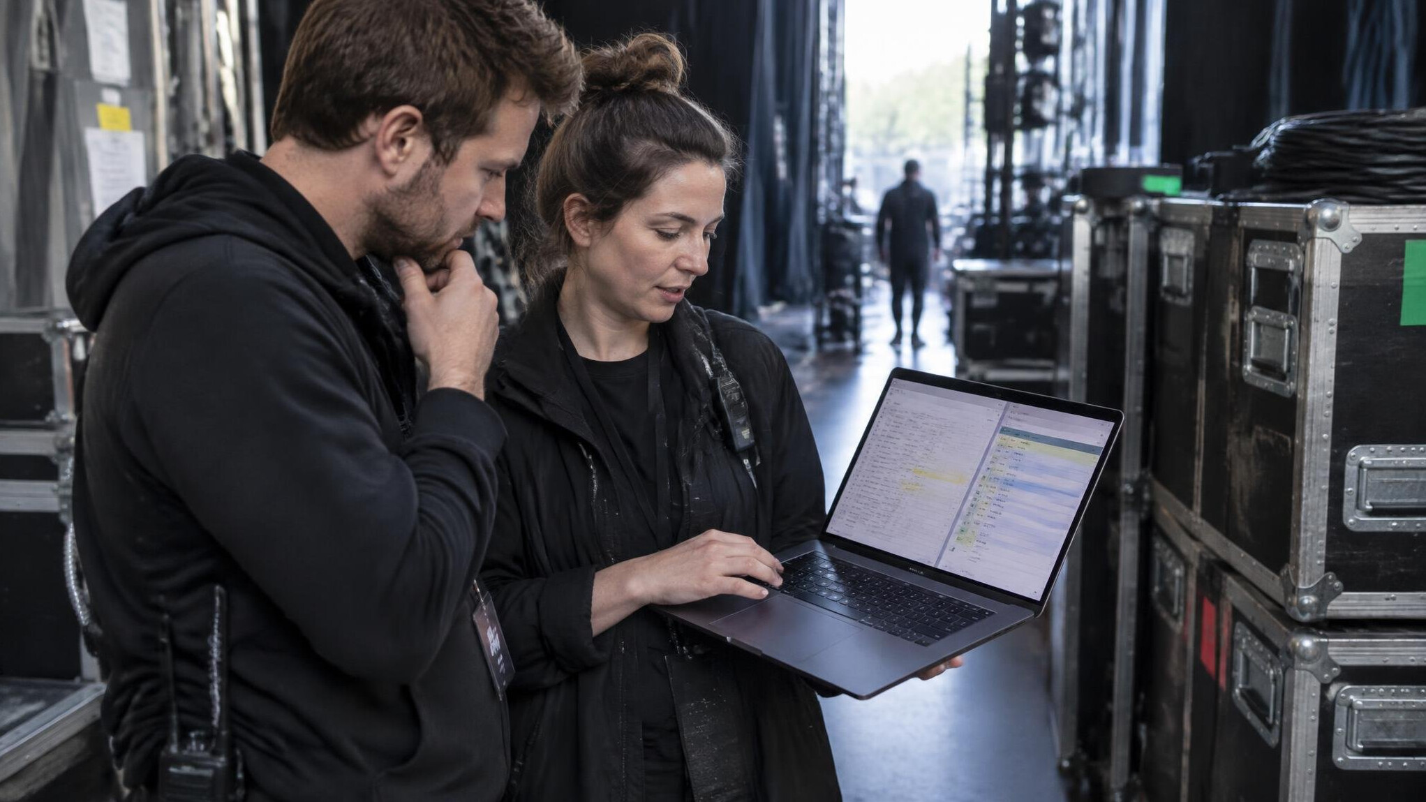 Production crew reviewing a shot list on a laptop before an event